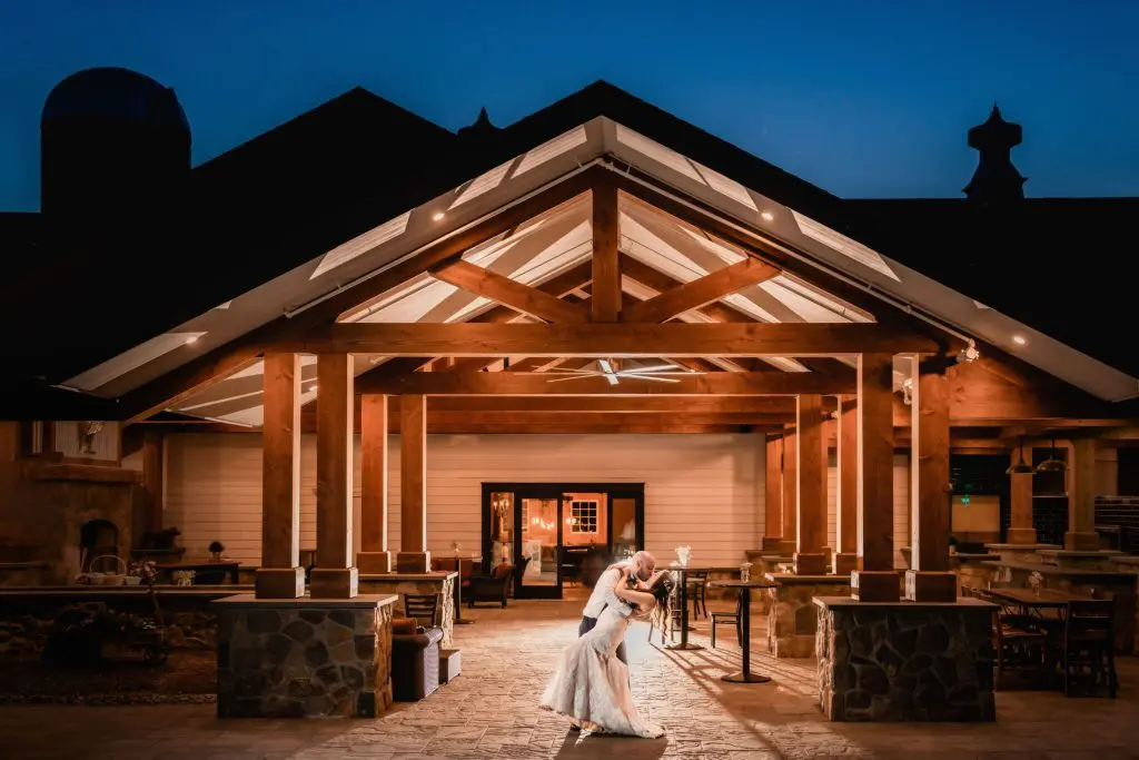 Bride and groom in front of barn at Perona Farms in Andover, NJ