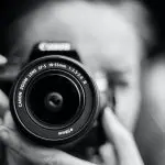 Photographer holding camera