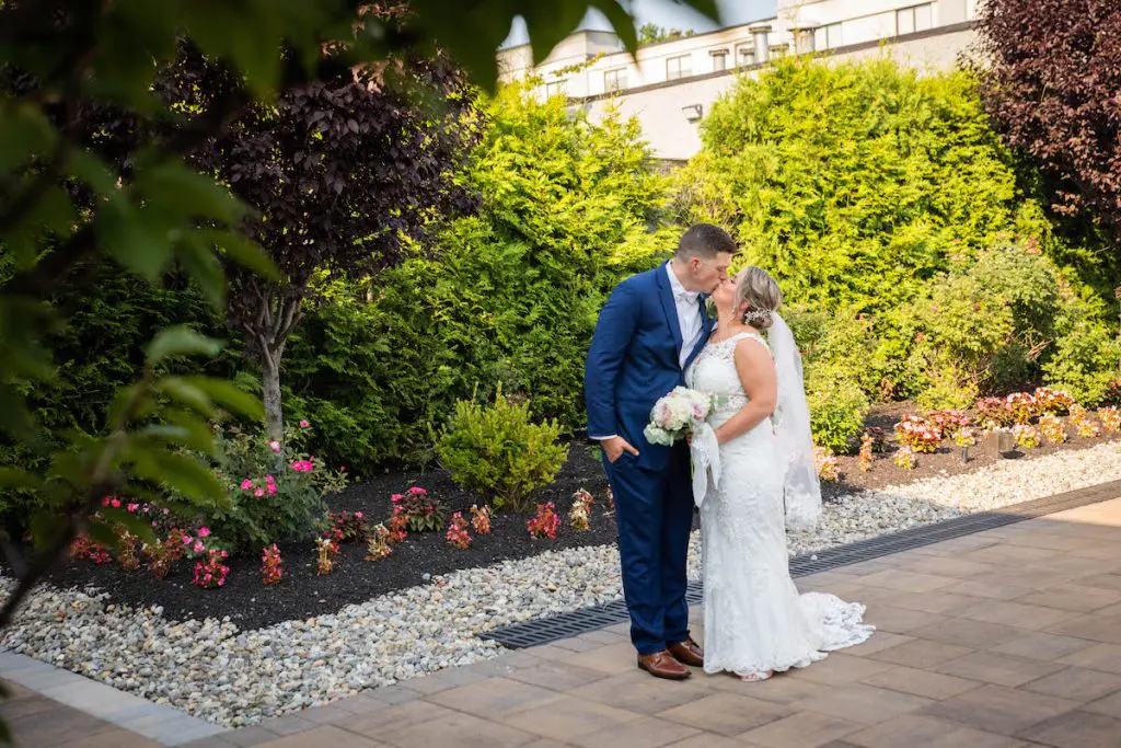 Bride and groom kissing outdoors