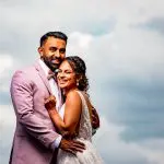 Bride and groom with cloudy sky