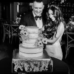 Bride and groom cutting cake