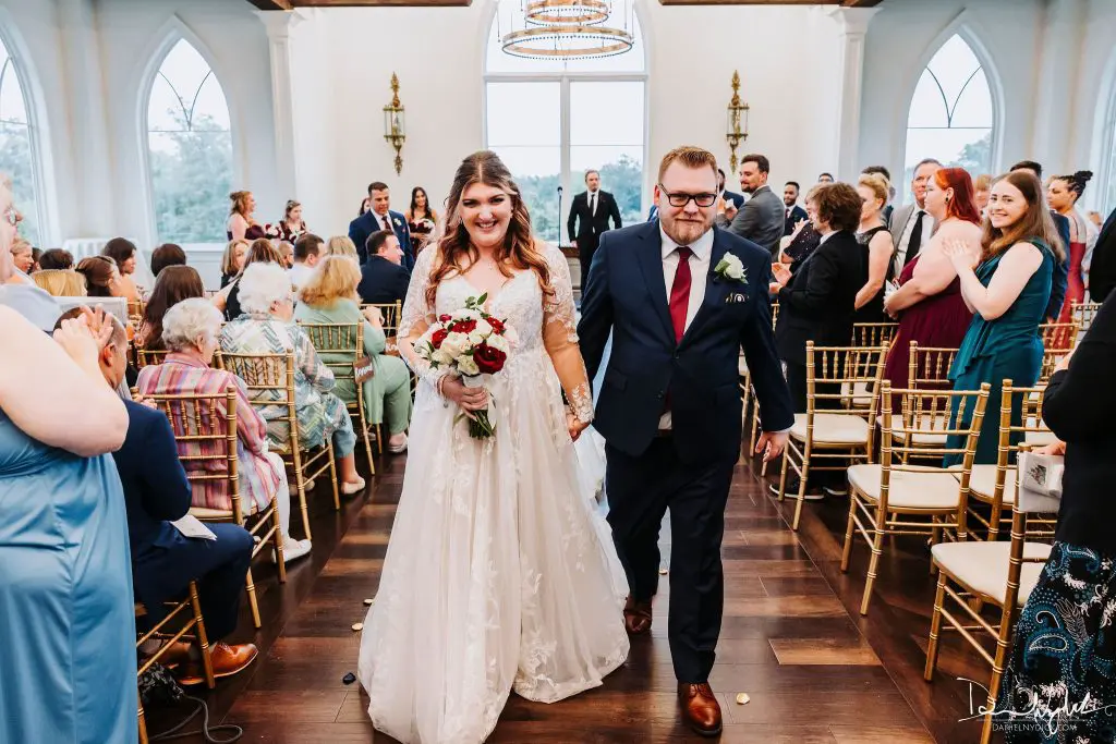 Bride and groom walking up aisle