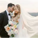Bride hold bouquet and groom outdoors at late Fall wedding at Natirar