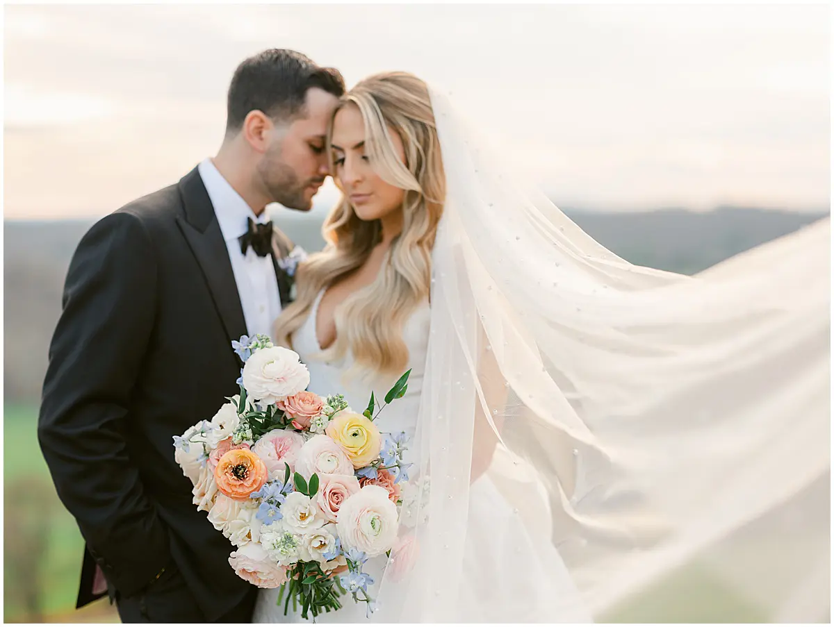 Bride hold bouquet and groom outdoors at late Fall wedding at Natirar