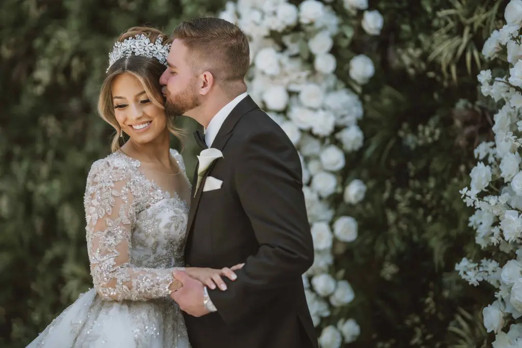 Groom kissing bride in Atrium at Perona Farms in Andover, NJ