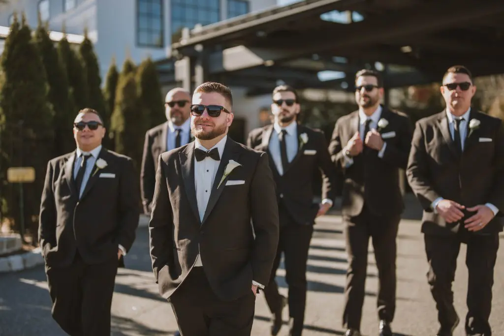 Groomsmen and groom in tuxedos