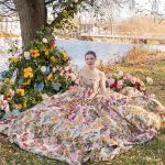 Bride sitting riverside at Red Mill Museum Village