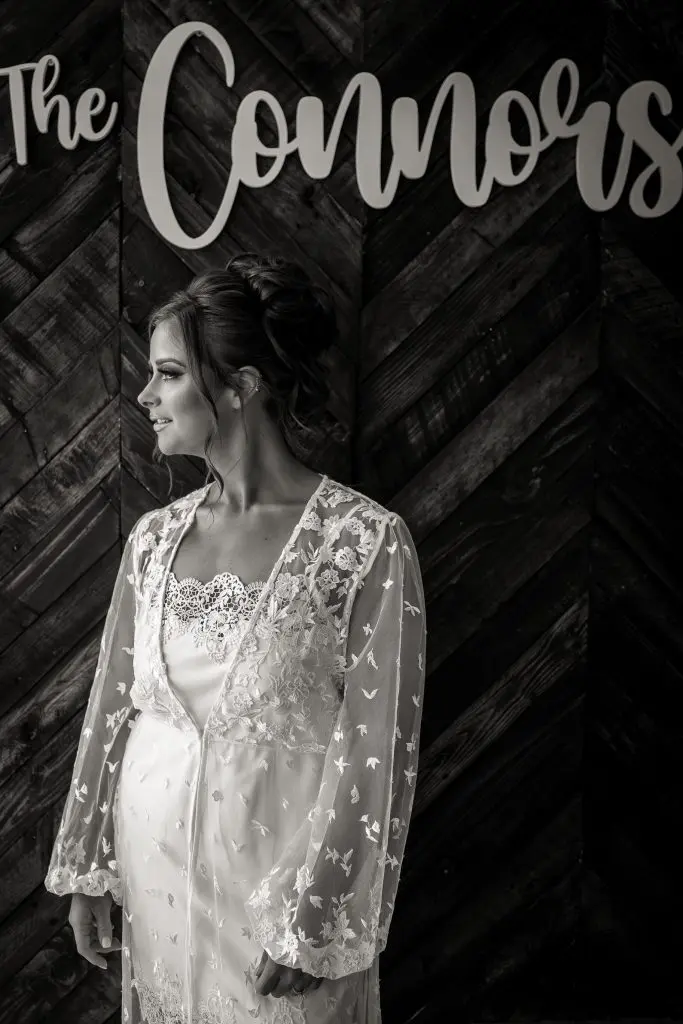 Bride in lace robe at wedding at Bear Brook Valley in Fredon, NJ