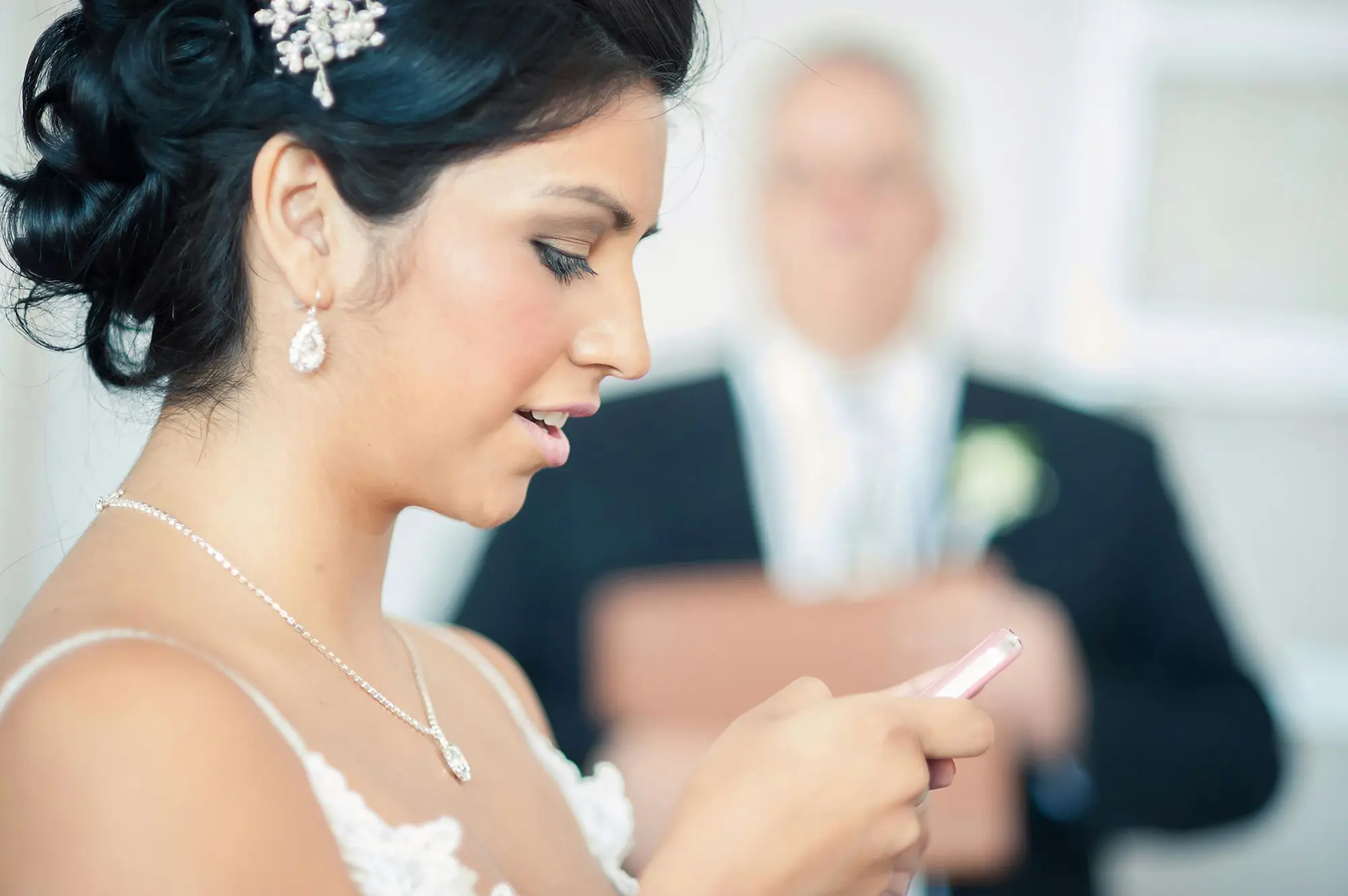 Bride looking at cell phone