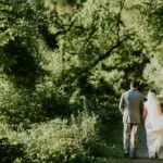 Wedding couple walking on path in woods