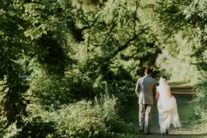 Wedding couple walking on path in woods
