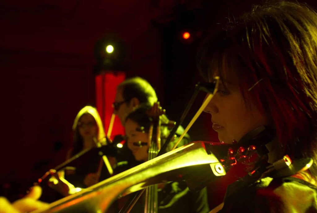 woman playing violin at wedding.
