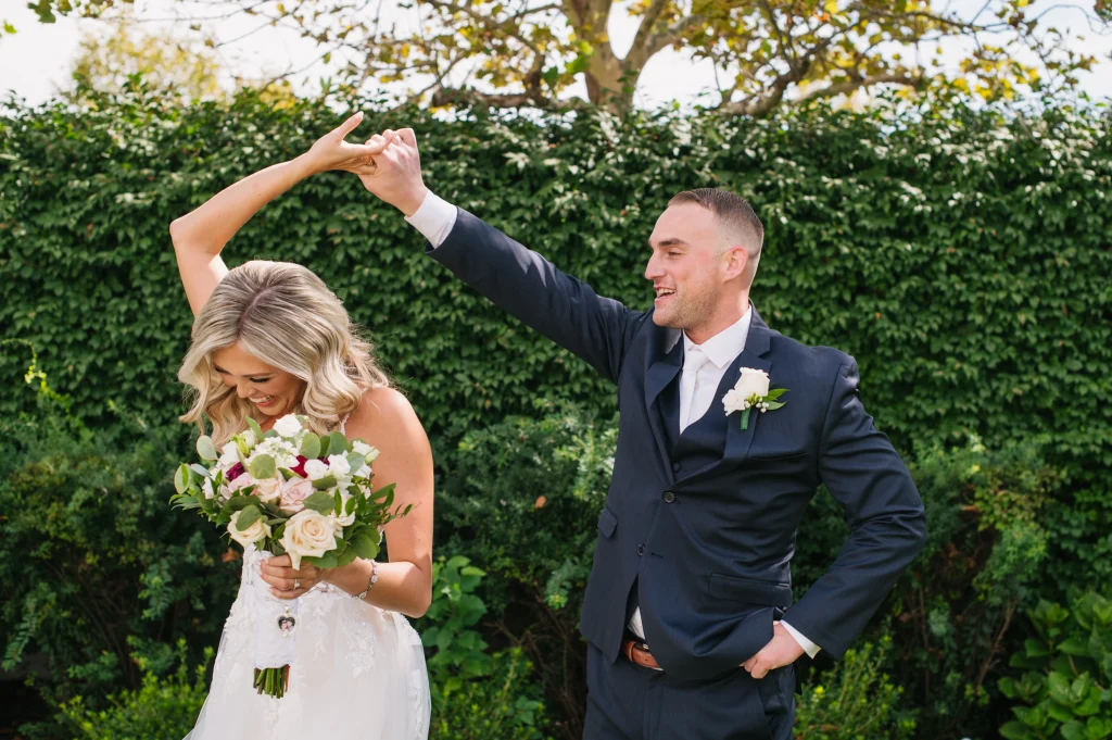 Bride and groom twirling outside