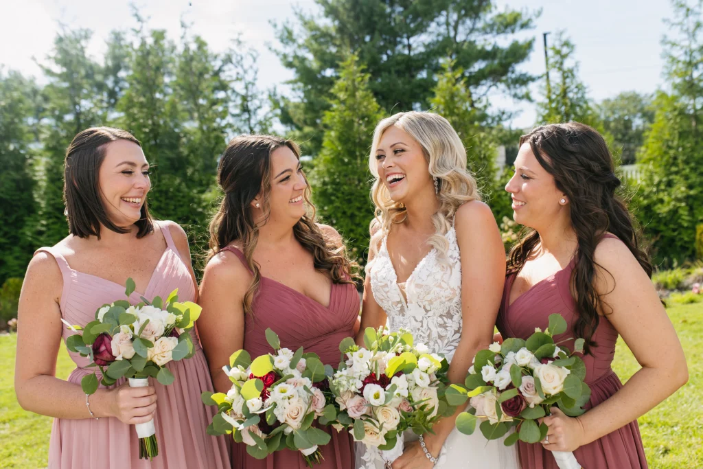 Bride with bridesmaids laughing