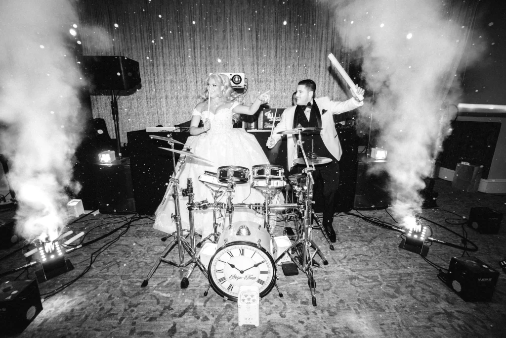 Bride and groom playing drums at wedding reception